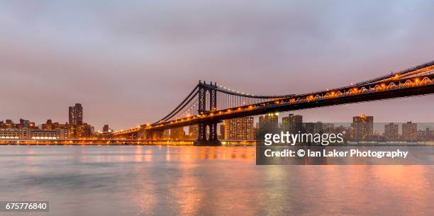 the manhattan bridge at dusk , viewed from brooklyn, new york city, usa. - manhattan bridge stock pictures, royalty-free photos & images