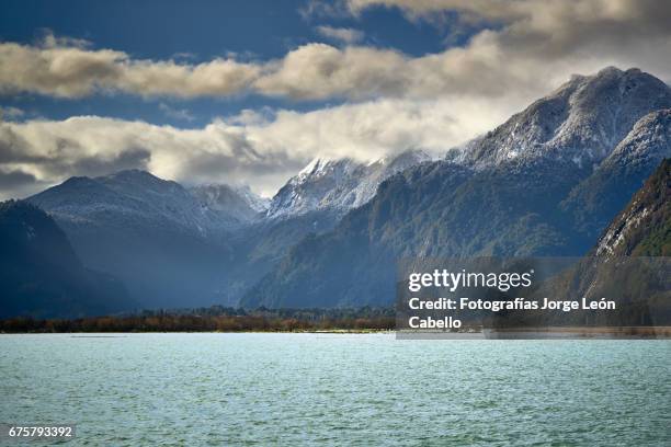 patagonian andes range view in peulla from the catamaran during winter the andean lake crossing - nevosa stock-fotos und bilder