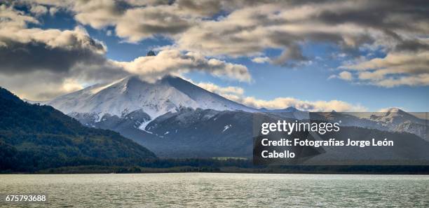 volcan puntiagudo view from the catamaran during the winter andean lake crossing - destinos turísticos stock pictures, royalty-free photos & images