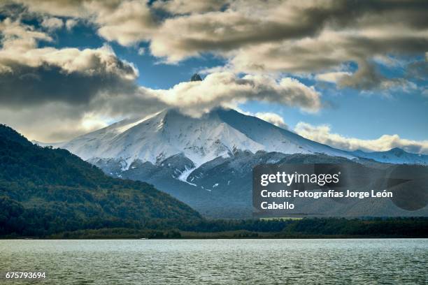 volcan puntiagudo view from the catamaran during the winter andean lake crossing - destinos turísticos stock pictures, royalty-free photos & images