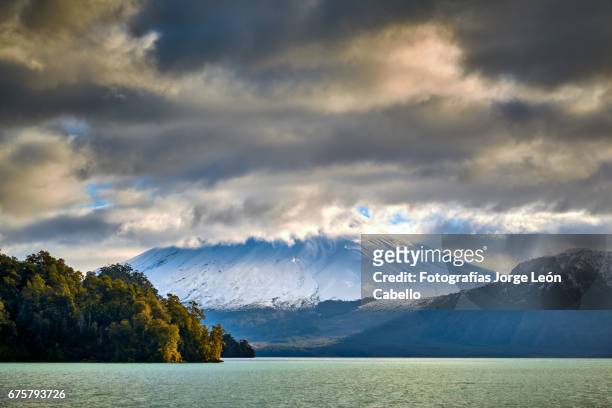 volcan osorno view from the catamaran during the winter andean lake crossing - luz del sol stock pictures, royalty-free photos & images