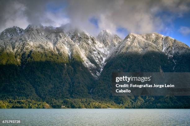 some of mountains surrounding lake todos los santos with a touch of afternoon winter sunlight - destinos turísticos stock-fotos und bilder