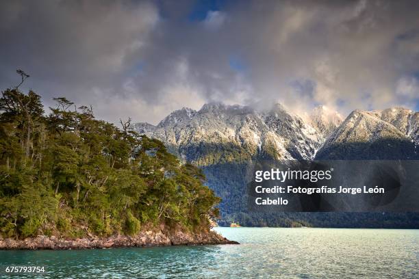 lake todos los santos surrounding winter view during the andean lake crossing - luz del sol stock pictures, royalty-free photos & images