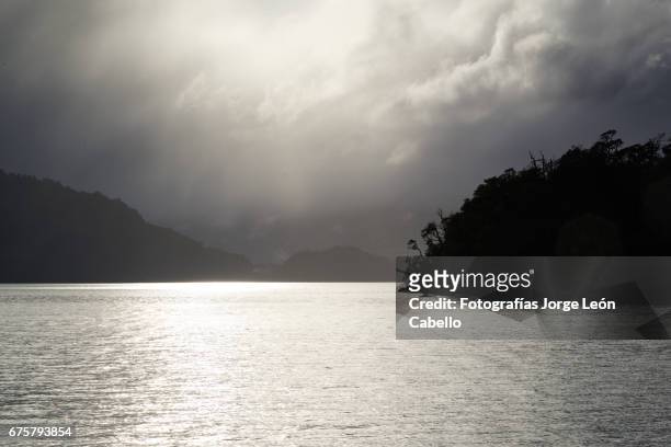the sunlight shines on the lake todos los santos during de andean lake crossing in winter - luz del sol stock pictures, royalty-free photos & images
