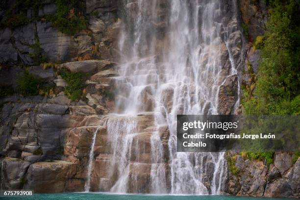 the waterfall of the lake todos los santos close view during the andean lake crossing - todos santos stockfoto's en -beelden