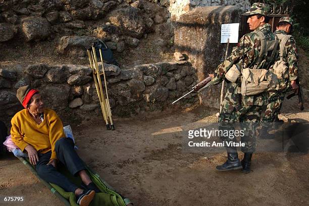 Wounded Nepalese villager rests at an army post near a water reservoir in Sundarijal, outside Kathmandu that had been attacked by Maoist insurgents...