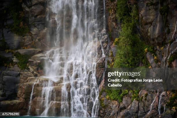 the waterfall of the lake todos los santos close view during the andean lake crossing - todos santos stockfoto's en -beelden