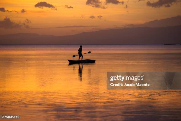 stand up paddle boarder at sunset - siquijor islands stock pictures, royalty-free photos & images