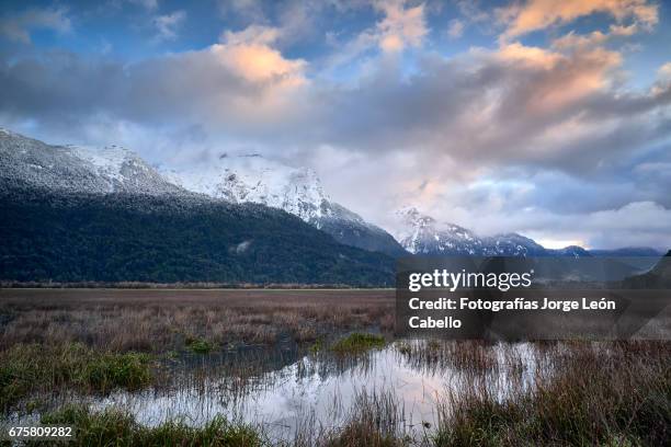 early morning winter sunlight over the patagonian andes and rio negro wetlands in peulla - luz del sol stock pictures, royalty-free photos & images