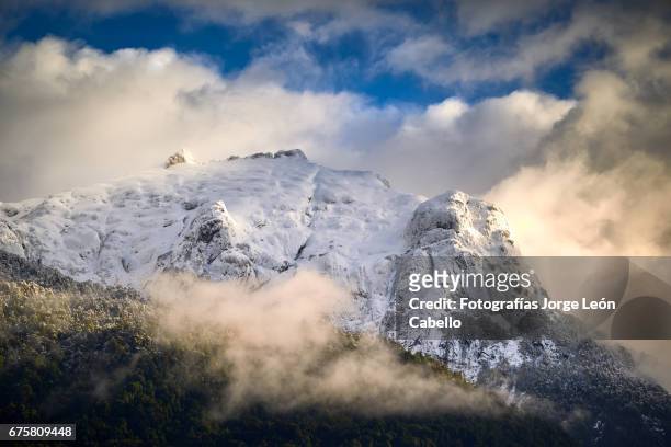 snowy cerro techado peak view from peulla in winter. - luz del sol stock pictures, royalty-free photos & images