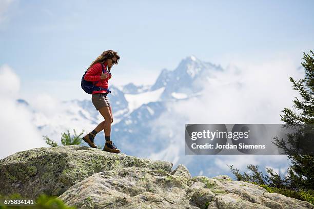 a woman hiking in the mountains. - mont blanc stock pictures, royalty-free photos & images