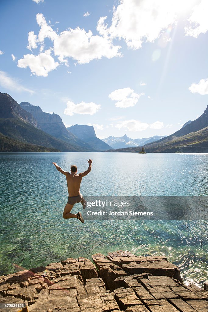 A man jumping into a lake