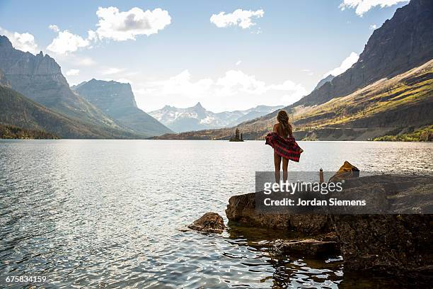 a woman standing on the shore of st. mary lake - lake whitefish stock-fotos und bilder