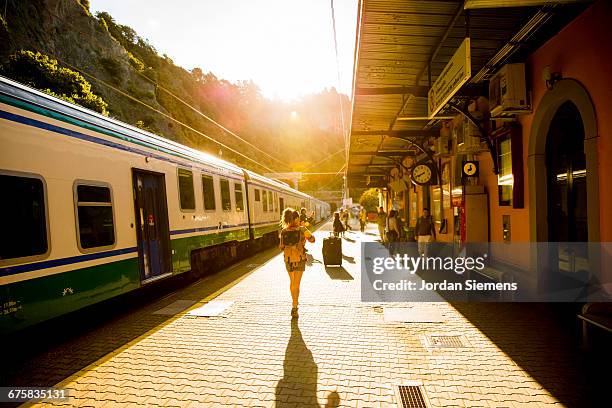 a female boarding a train. - station de vacances fotografías e imágenes de stock