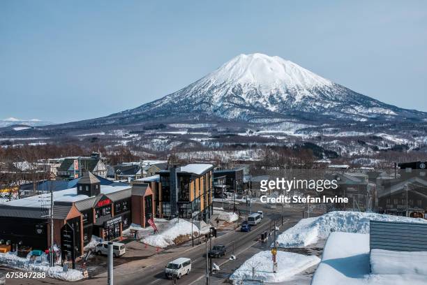 The snow-capped Mount Yotei, a dormant volcano in Niseko, Japan, as viewed in the evening light from the village of Grand Hirafu.