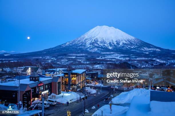 The snow-capped Mount Yotei, a dormant volcano in Niseko, Japan, as viewed in the evening light from the village of Grand Hirafu.