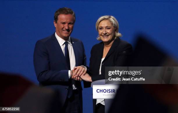 French presidential candidate Marine Le Pen of 'Front National' party is joined on stage by Nicolas Dupont-Aignan, President of 'Debout la France'...