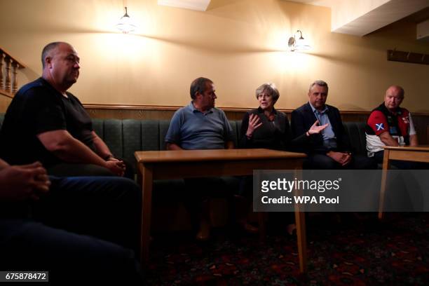 Britain's Prime Minister Theresa May chats to local fishermen on a campaign stop on May 2, 2017 in Mevagissey, Cornwall, England. The Prime Minister...