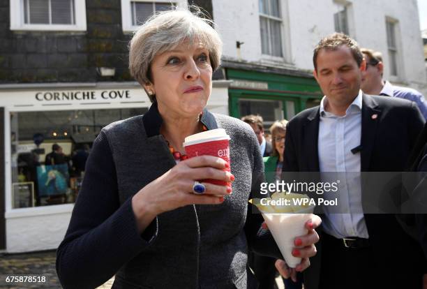 Britain's Prime Minister Theresa May enjoys some chips during a campaign stop on May 2, 2017 in Mevagissey, Cornwall, England. The Prime Minister is...