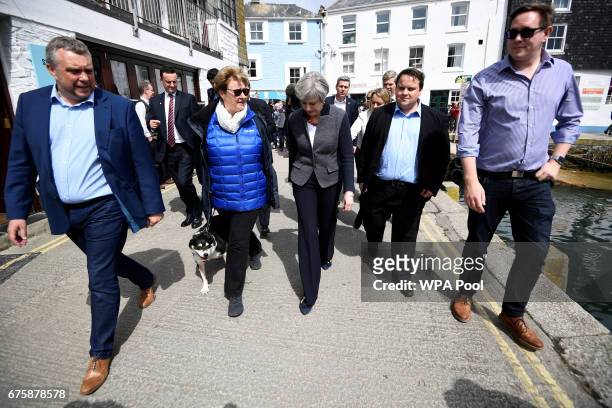 Britain's Prime Minister Theresa May walks during a campaign stop on May 2, 2017 in Mevagissey, Cornwall, England. The Prime Minister is campaigning...