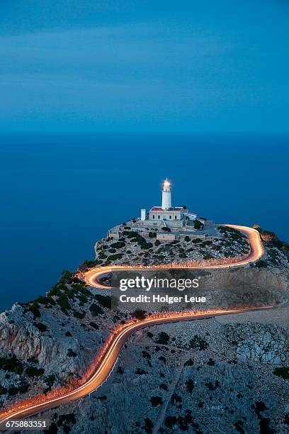 car light streaks on road to formentor lighthouse - cabo formentor stock pictures, royalty-free photos & images