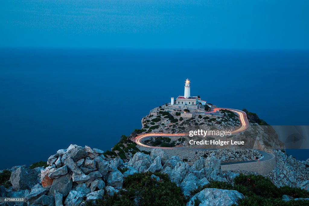 Car light streaks on road to Formentor lighthouse