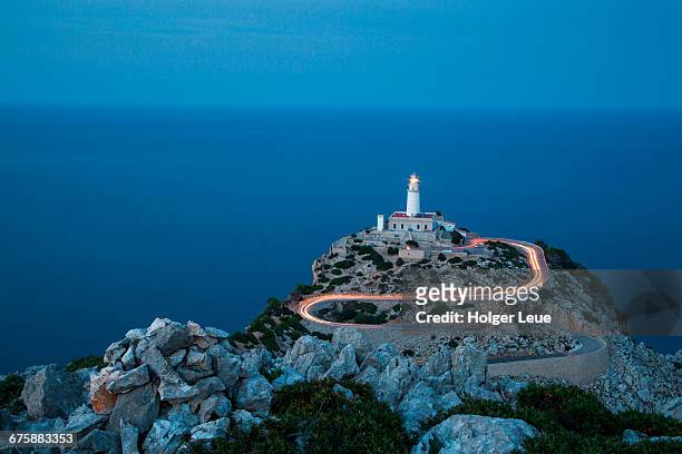 car light streaks on road to formentor lighthouse - lighthouse mallorca stock pictures, royalty-free photos & images