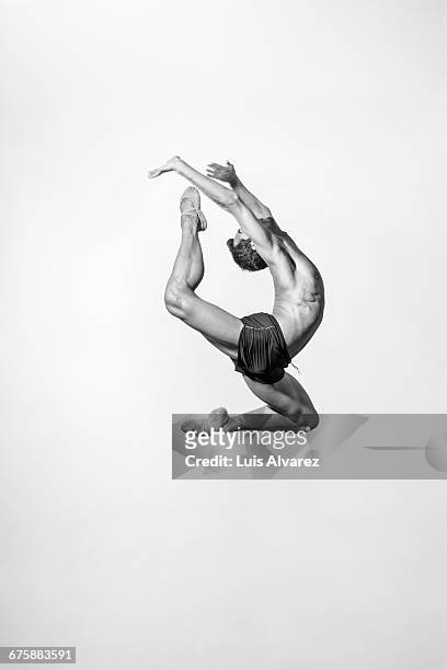 male ballet dancer against white background - saut elastique photos et images de collection