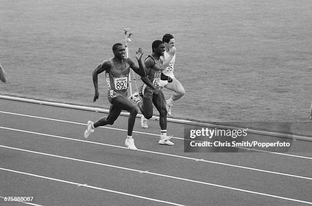 American track and field athlete Carl Lewis competes to cross the finish line in first place to win the gold medal in the final of the men's 100...