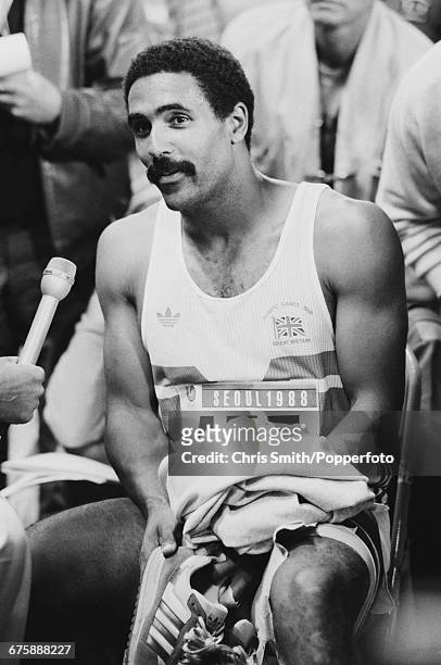 Daley Thompson of Great Britain is interviewed during a break in the men's decathlon competition inside the Olympic Stadium at the 1988 Summer...