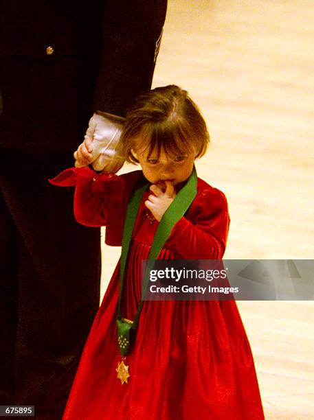 Police officer James Smith, holds hands with his daughter Patricia after receiving the police medal of honor on behalf of wife and mother, police...