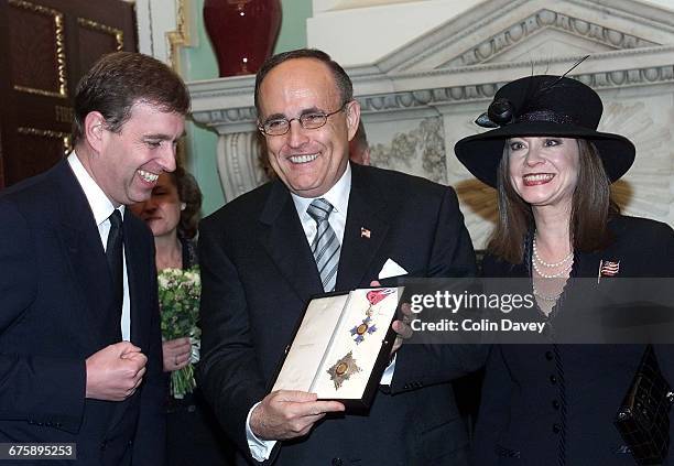 New York Mayor Rudy Giuliani holding an honorary knighthood and standing with his partner Judith Nathan and Prince Andrew Duke Of York , Mansion...