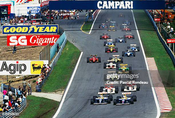 Nigel Mansell drives the Canon Williams Renault Williams FW14 Renault 3.5 V10 ahead of team mate Riccardo Patrese at the start of the Portuguese...