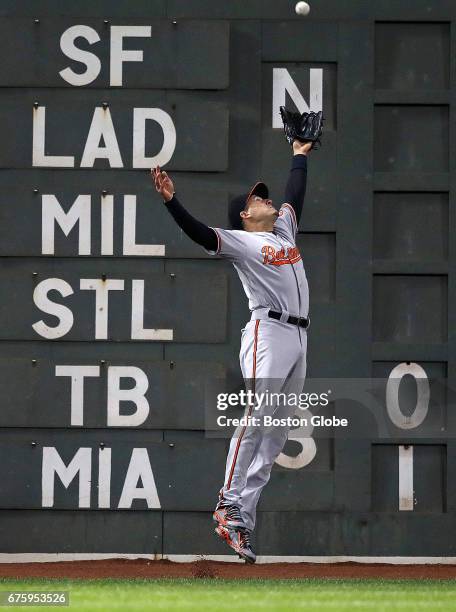 Orioles left fielder Ryan Flaherty leaps but can't make the play on a third inning double hit by Red Sox player Xander Bogaerts, the first hit of the...