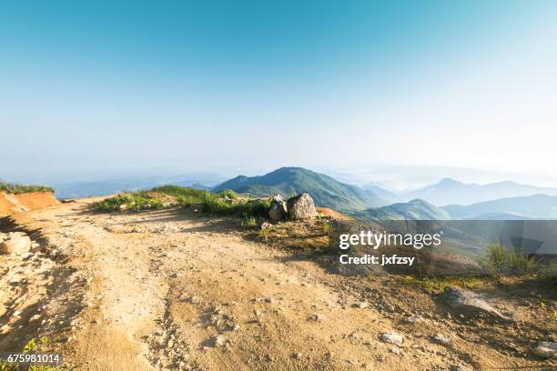 rock stone road in sunrise with tire imprint for automobile commercial - rocky mountain road stock pictures, royalty-free photos & images
