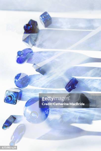 blue glass bottles - catherine macbride stockfoto's en -beelden