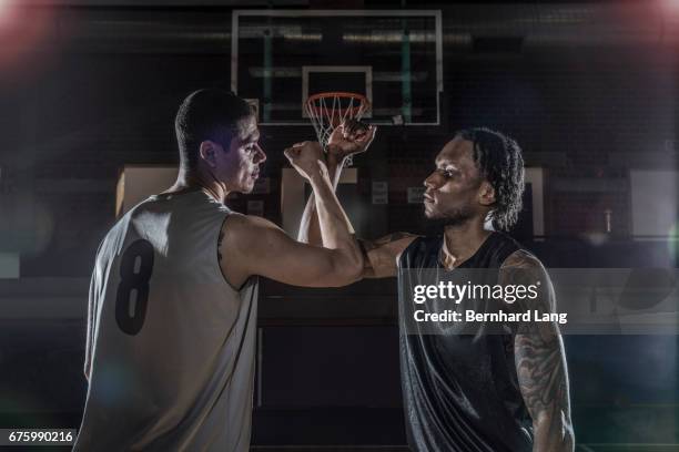 two basketball player fist bump each other - sportmannschaft stock pictures, royalty-free photos & images