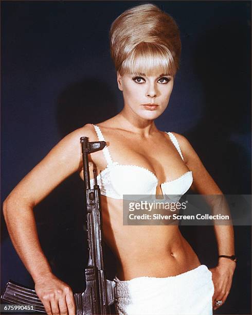 German actress Elke Sommer as assassin Irma Eckman, wielding a submachine gun in a publicity still for the film 'Deadlier Than the Male', 1967.