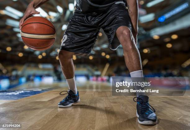 basketball player dribbling, close up - basketball shoe stock-fotos und bilder