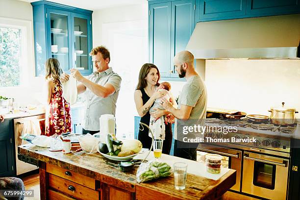 husband and wife with newborn baby in kitchen - kitchen dresser stock pictures, royalty-free photos & images