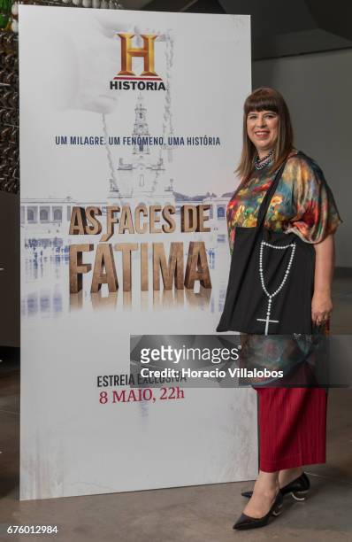 Portuguese artist Joana Vasconcelos poses in front of the documentary poster while showing rosary bags during a press conference with Managing...