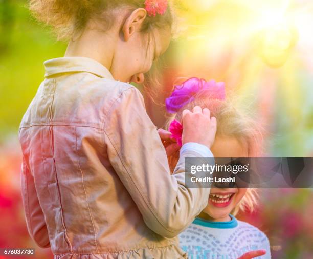 children playing together outdoors - laoshi stock pictures, royalty-free photos & images