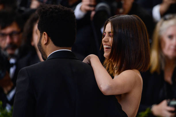 Singer The Weeknd and actress Selena Gomez enter the Rei Kawakubo/Comme des Garcons: Art Of The In-Between