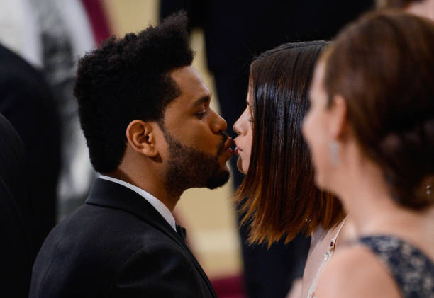 Singer The Weeknd and actress Selena Gomez enter the Rei Kawakubo/Comme des Garcons: Art Of The In-Between