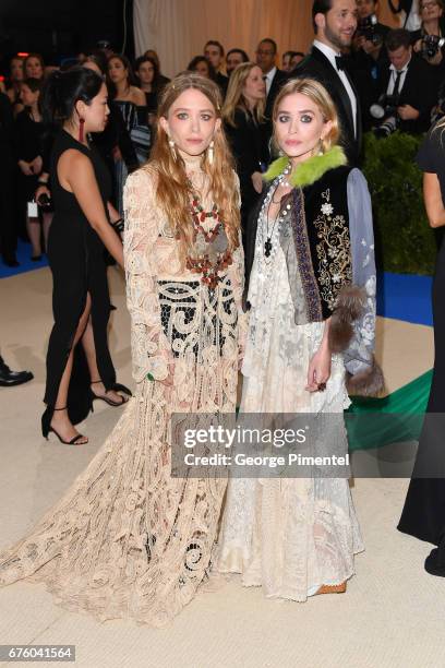 Mary-Kate Olsen and Ashley Olsen attend the 'Rei Kawakubo/Comme des Garcons: Art Of The In-Between' Costume Institute Gala at Metropolitan Museum of...