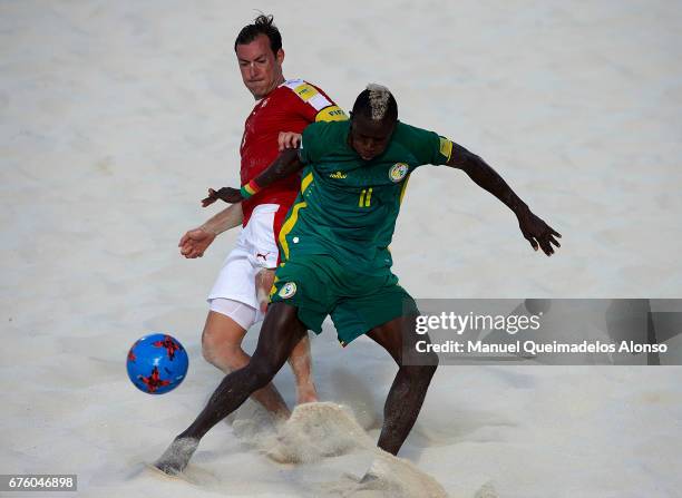 Moritz Jaeggy of Switzerland competes for the ball with Ibrahima Balde of Senegal during the FIFA Beach Soccer World Cup Bahamas 2017 group A match...