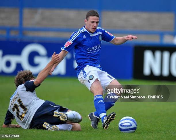 Macclesfield Town's John Rooney and Lincoln City's Sergio Torres battle for the ball