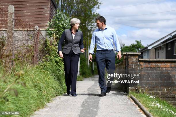 Britain's Prime Minister Theresa May walks with local Conservative Party candidate Johnny Mercer during a campaign visit on May 2, 2017 in Plymouth,...