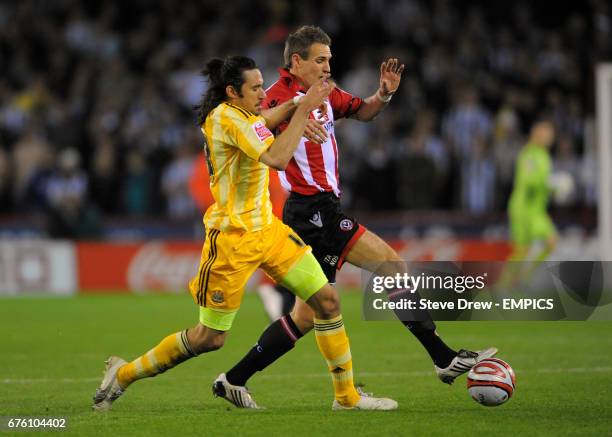 Sheffield United's Matt Kilgallon and Newcastle United's Jonas Gutierrez battle for the ball