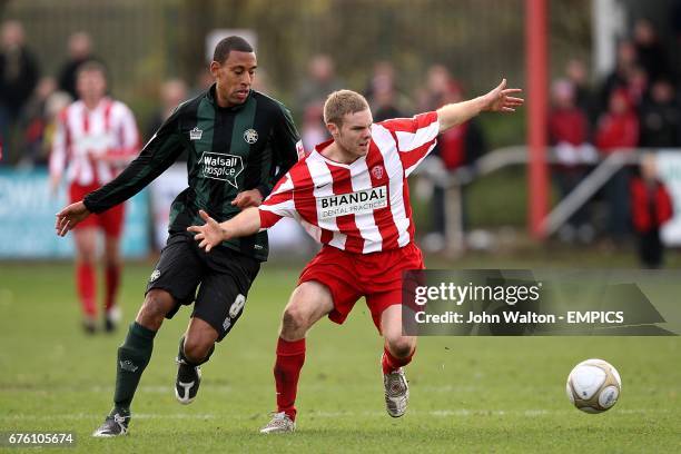 Stourbridge's Sean Evans and Walsall's Dwayne Mattis battle for the ball